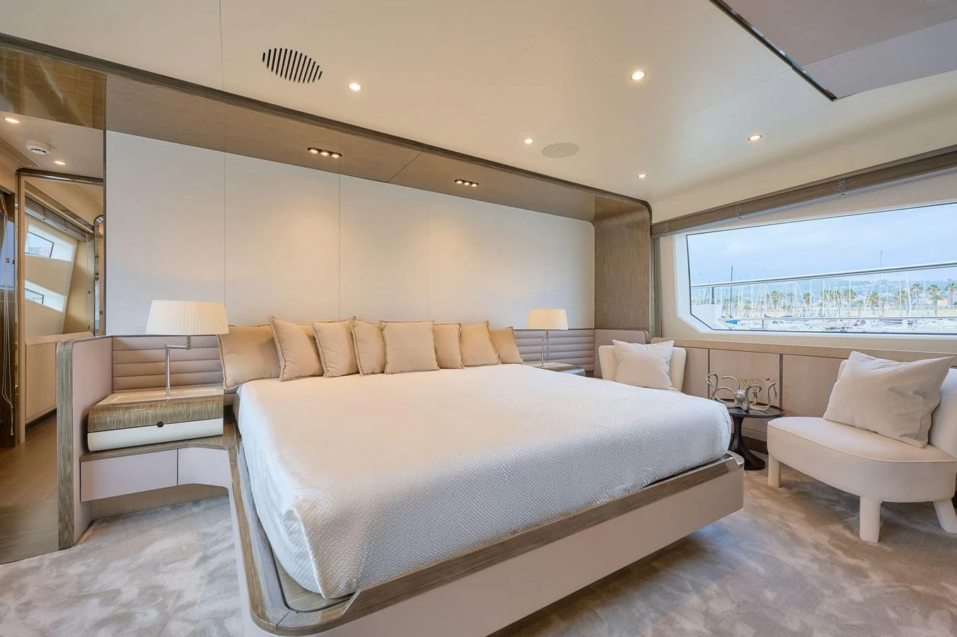 The master stateroom features a spacious bed with elegant decor and ample natural light. aboard SUN & SEA Yacht for Sale