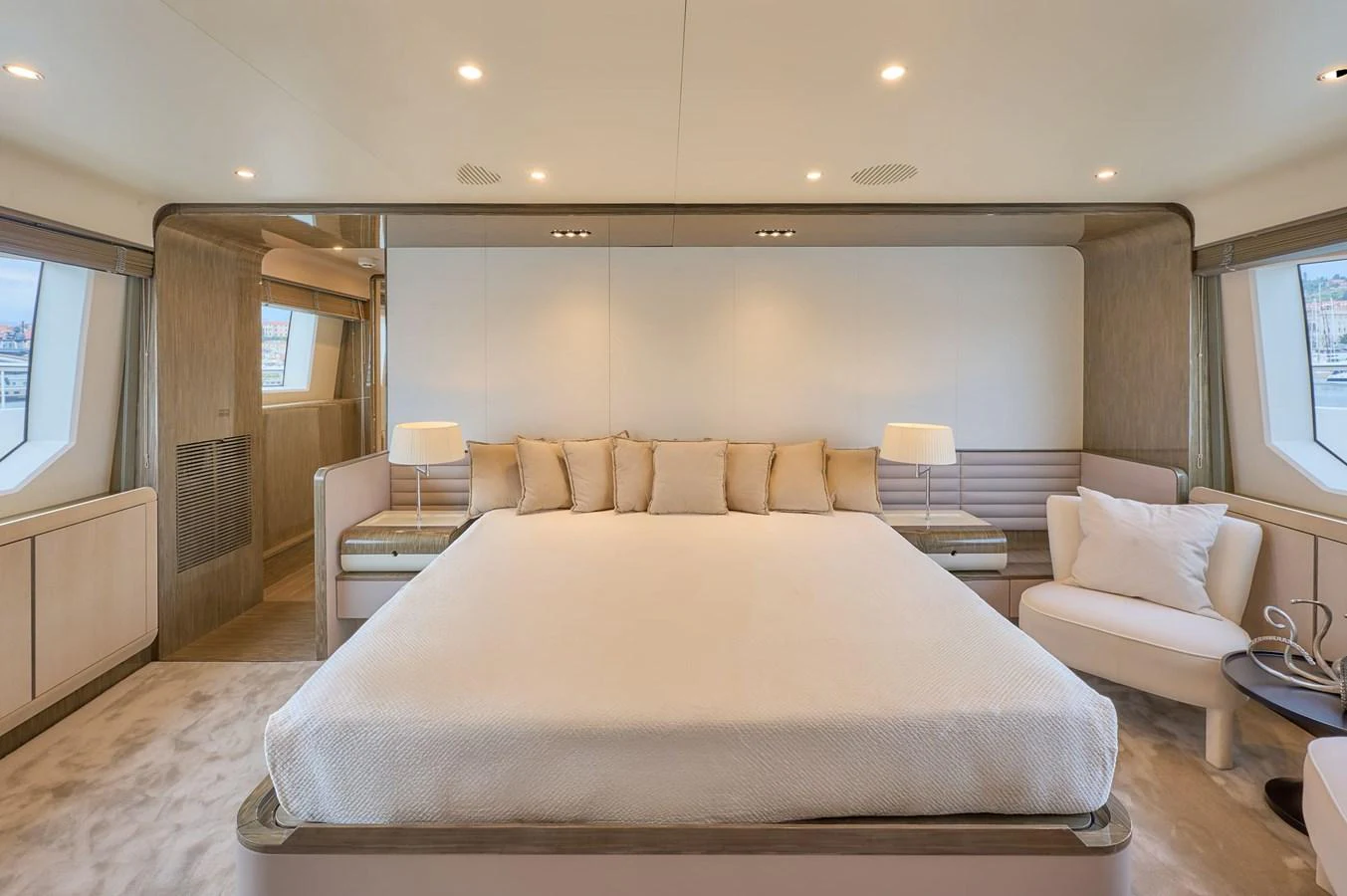 The master stateroom features a spacious bed with elegant decor and ample natural light. aboard SUN & SEA Yacht for Sale
