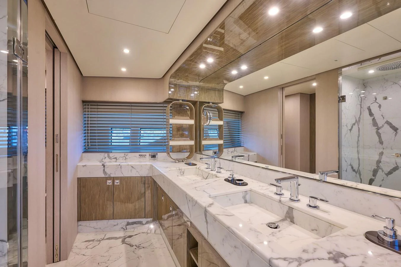 The yacht's bathroom features a luxurious marble countertop with dual sinks and modern fixtures. aboard SUN & SEA Yacht for Sale
