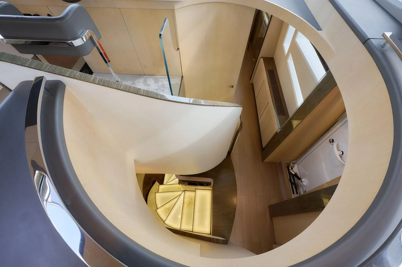 A stunning spiral staircase with modern design elements inside a luxurious yacht. aboard SUN & SEA Yacht for Sale