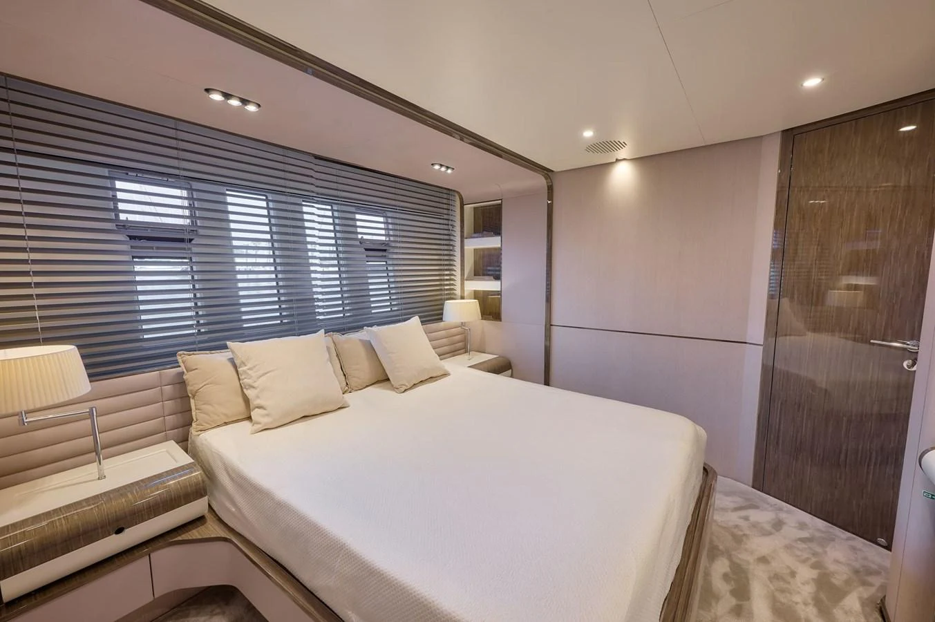 The stateroom features a luxurious bed with elegant bedding and modern lighting. aboard SUN & SEA Yacht for Sale