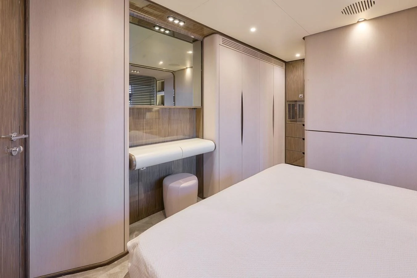 The stateroom features a modern design with ample storage and a vanity area. aboard SUN & SEA Yacht for Sale