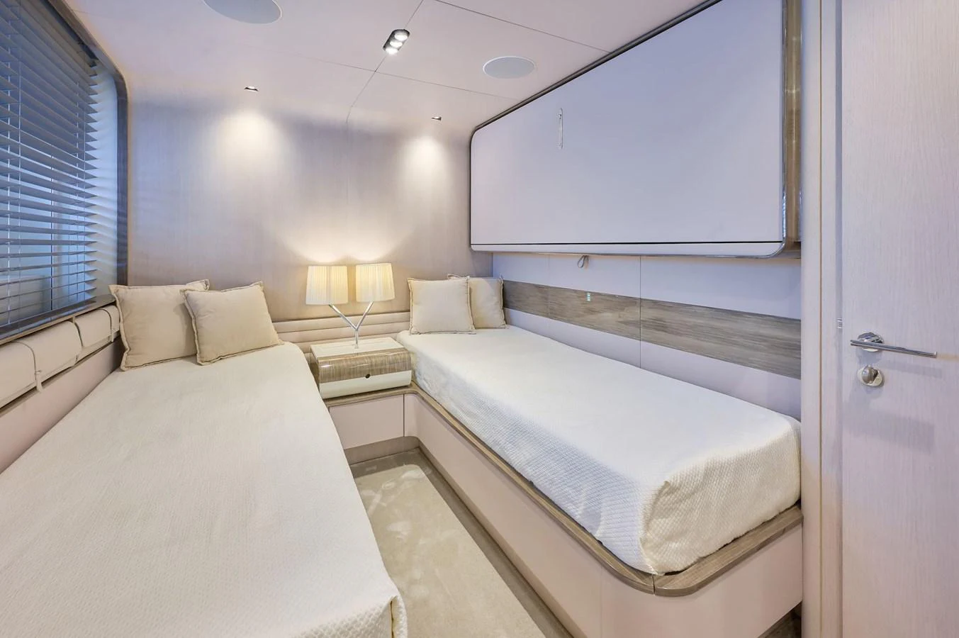 The guest stateroom features twin beds and a serene, modern design. aboard SUN & SEA Yacht for Sale