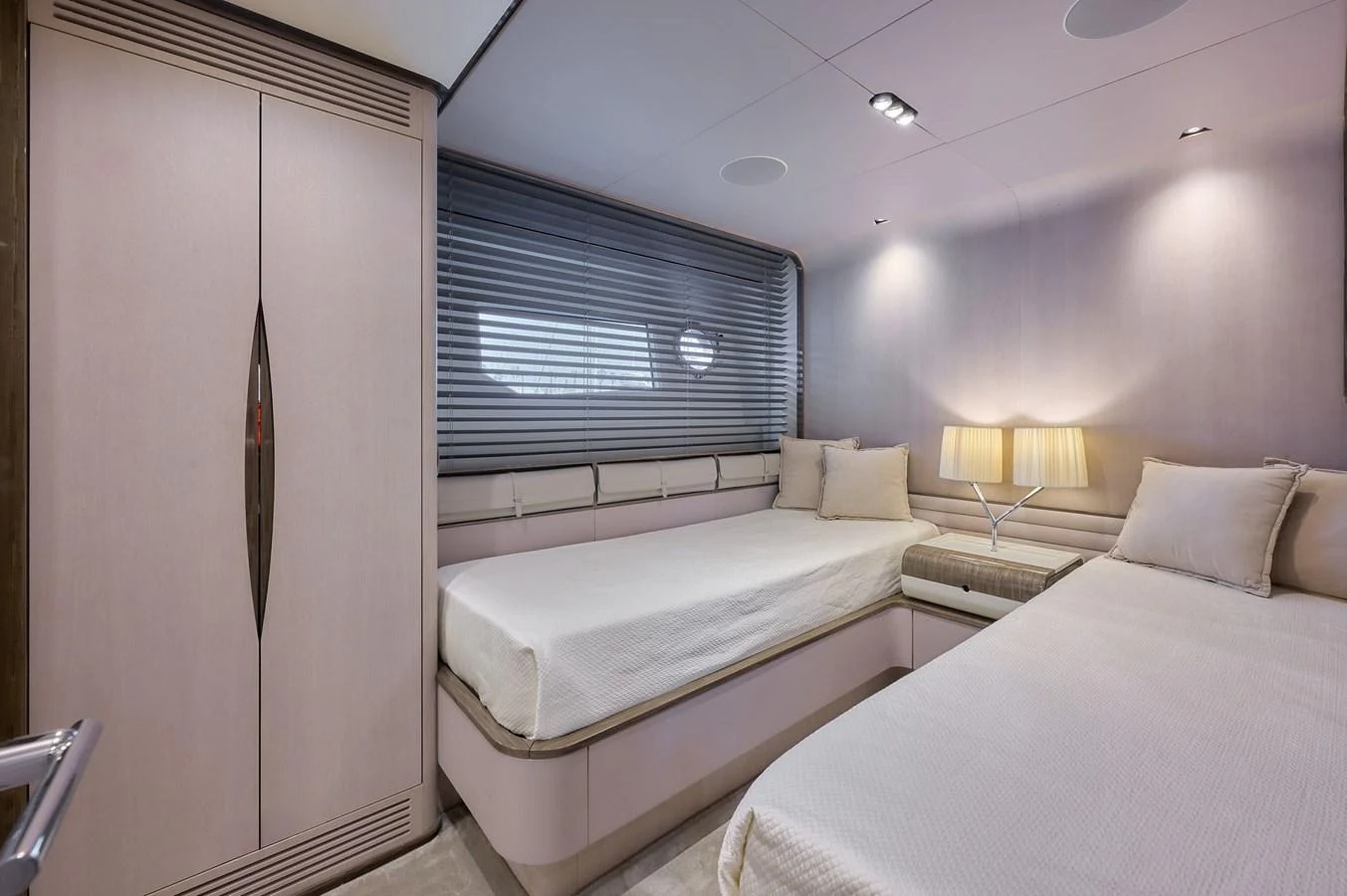 The guest stateroom features twin beds and a serene, modern design. aboard SUN & SEA Yacht for Sale
