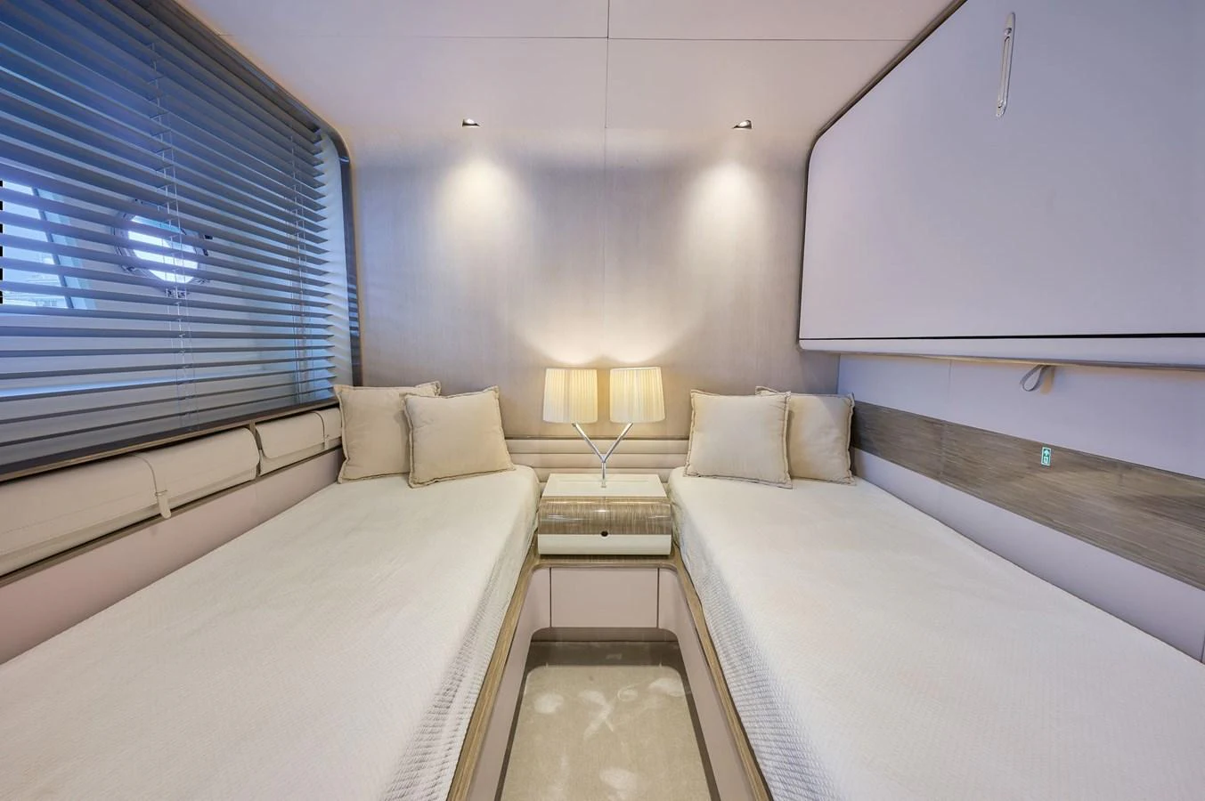 The twin stateroom features two single beds with a modern, minimalist design and soft lighting. aboard SUN & SEA Yacht for Sale