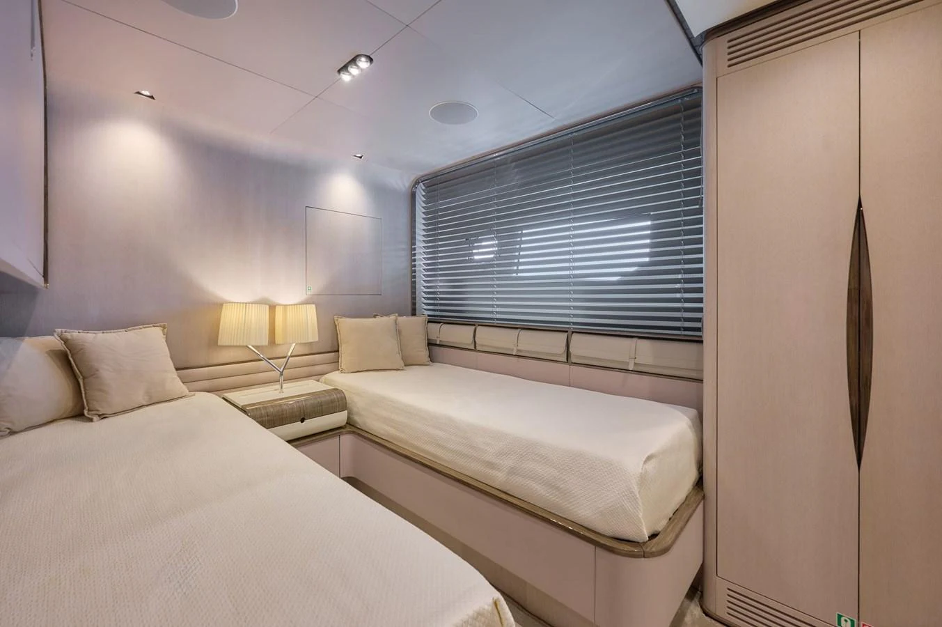 The guest stateroom features twin beds with elegant lighting and modern decor. aboard SUN & SEA Yacht for Sale