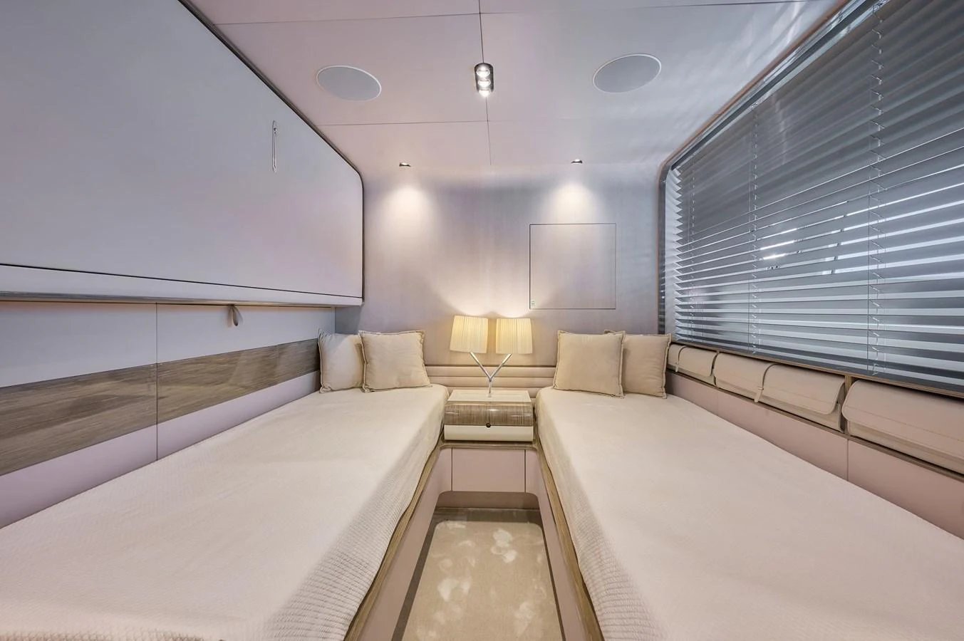 The twin stateroom features two comfortable beds with a modern and elegant design. aboard SUN & SEA Yacht for Sale
