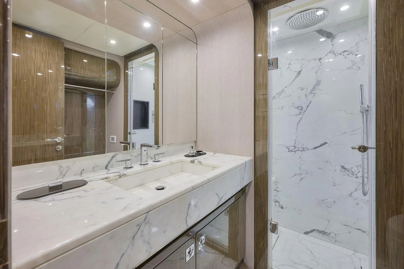 The yacht's bathroom features a luxurious marble sink and a spacious glass-enclosed shower. aboard SUN & SEA Yacht for Sale