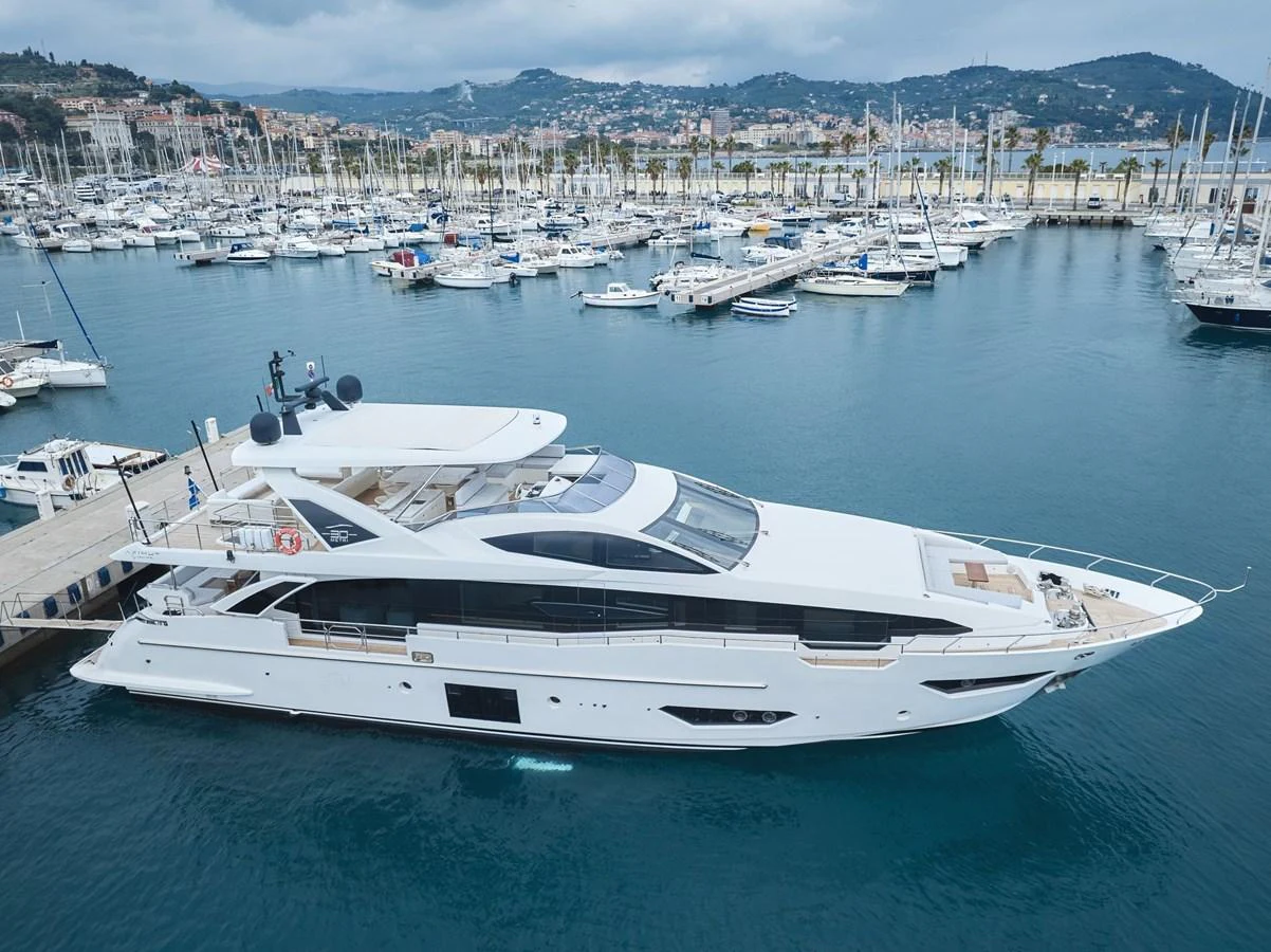 A sleek and modern yacht docked at a marina, showcasing its elegant design and spacious decks. aboard SUN & SEA Yacht for Sale