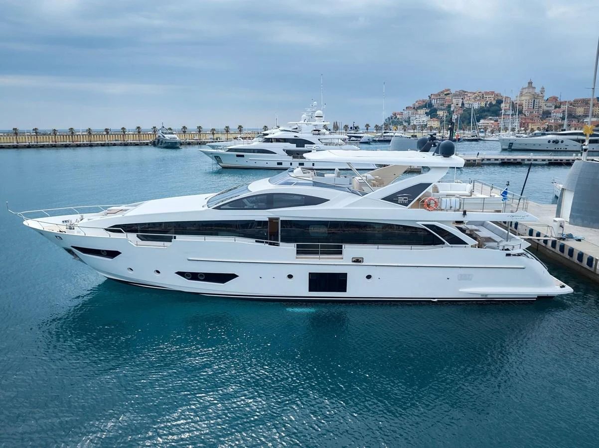 A sleek and modern yacht is docked in a picturesque marina, showcasing its elegant design and spacious decks. aboard SUN & SEA Yacht for Sale