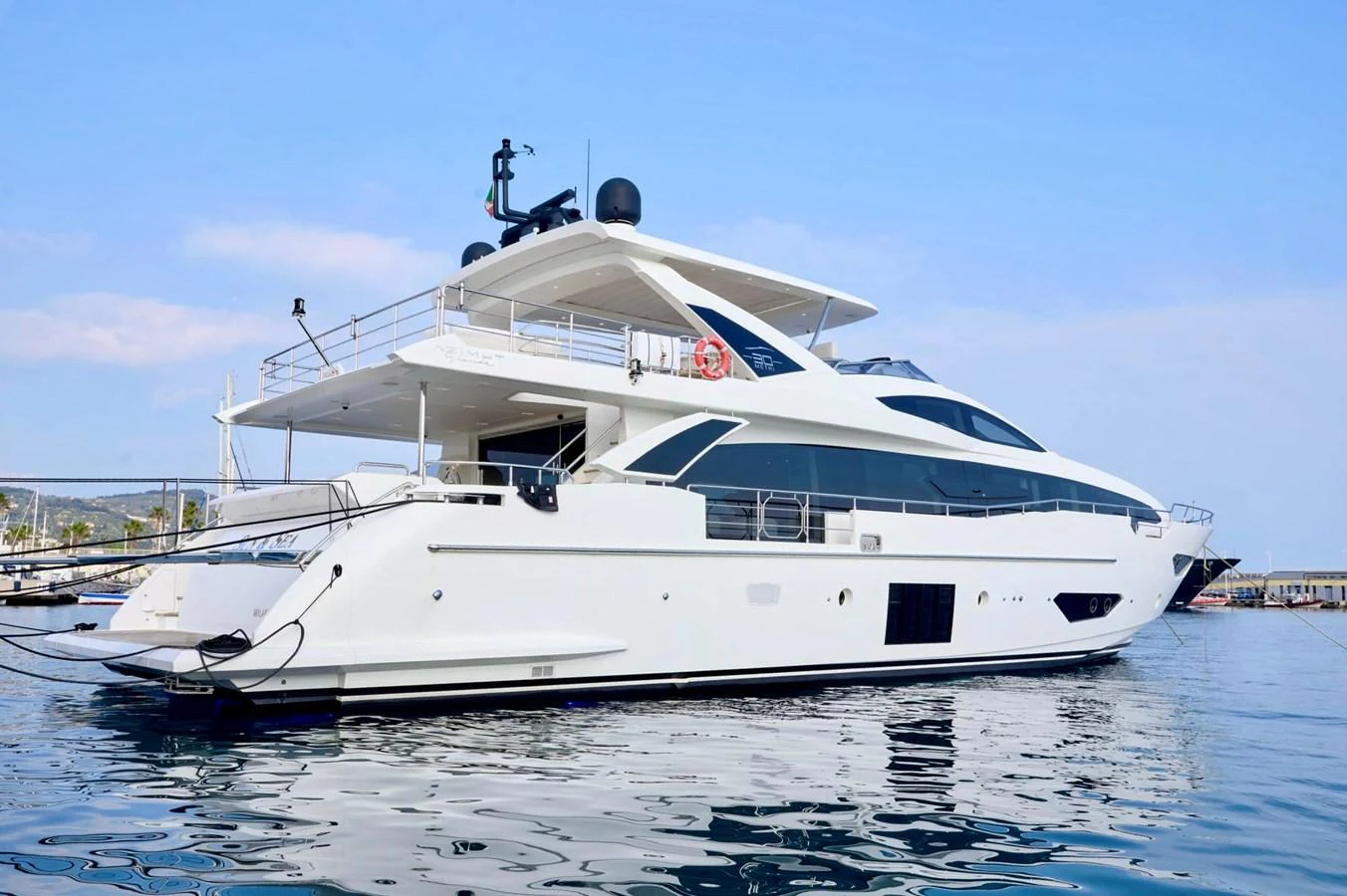 A sleek and modern yacht is docked at the marina, showcasing its elegant lines and spacious decks. aboard SUN & SEA Yacht for Sale