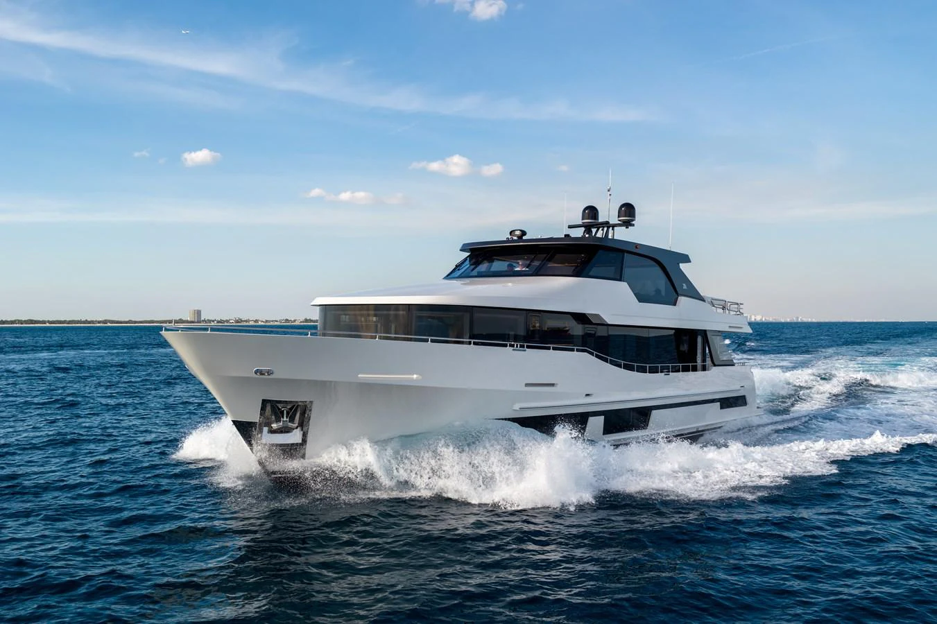 A sleek and modern yacht cruises swiftly through the open water under a clear blue sky. aboard OCEAN ALEXANDER 28L Yacht for Sale