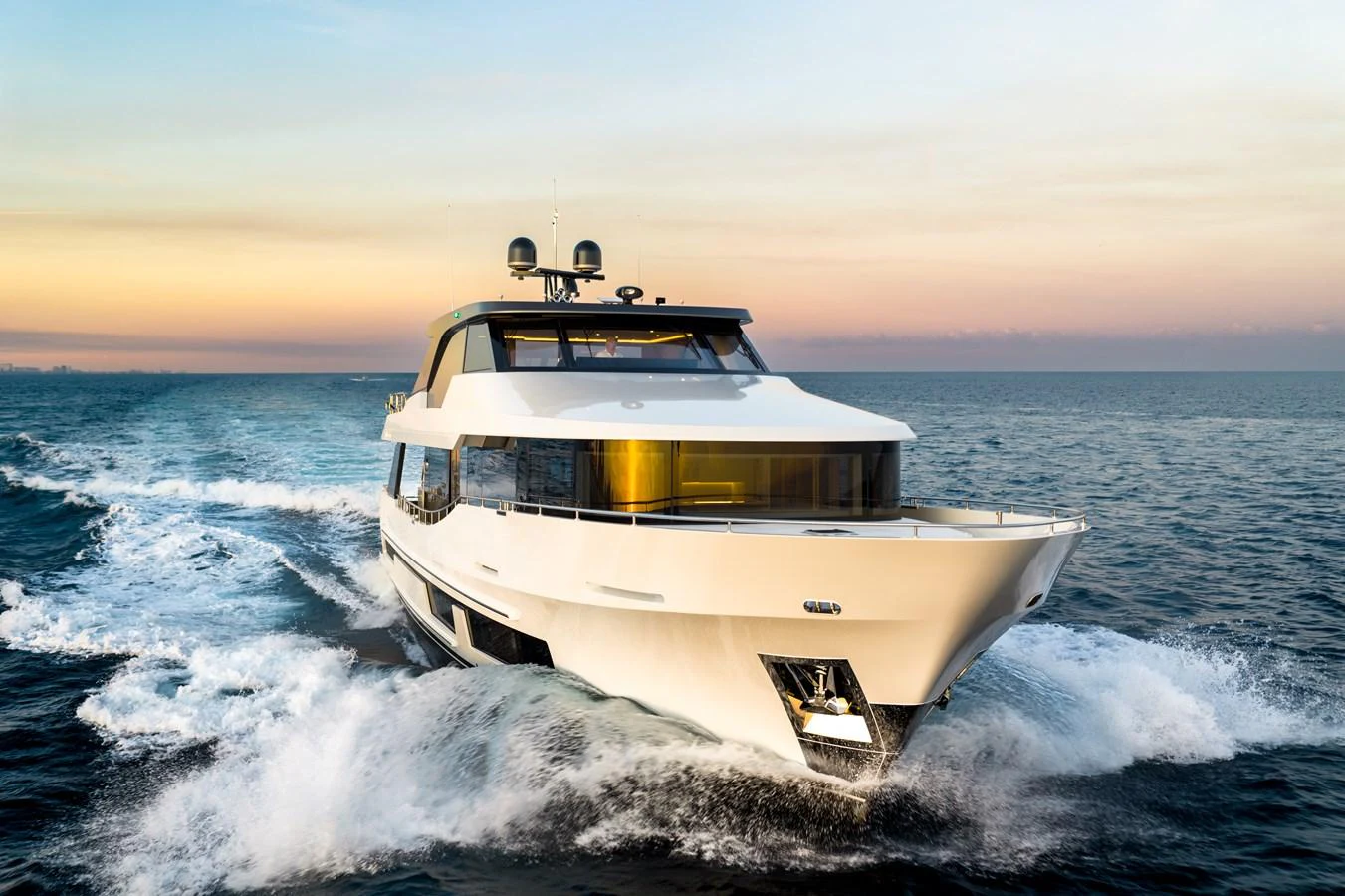 A sleek and modern yacht cruises powerfully through the open sea at sunset. aboard OCEAN ALEXANDER 28L Yacht for Sale