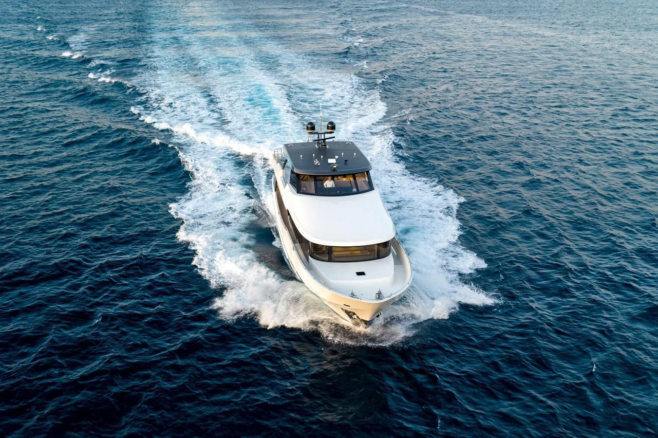 A sleek yacht cruises through the open water, leaving a trail of white foam behind. aboard OCEAN ALEXANDER 28L Yacht for Sale