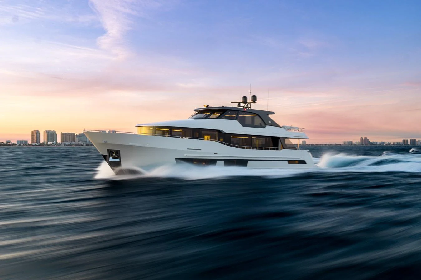 A sleek yacht cruises swiftly through the water at sunset, showcasing its modern design and luxurious amenities. aboard OCEAN ALEXANDER 28L Yacht for Sale