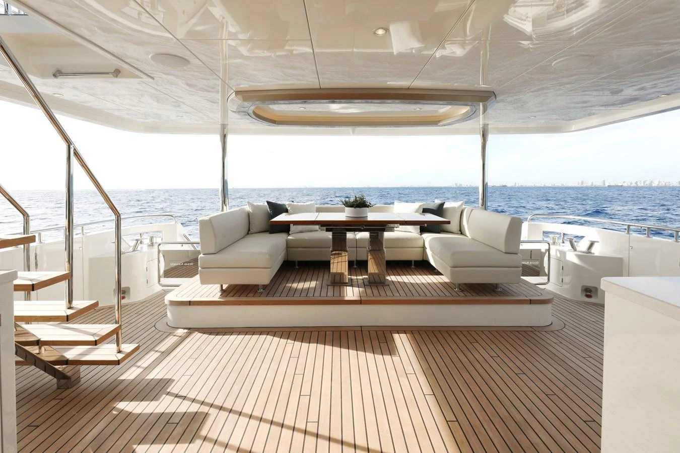 The aft deck features a spacious seating area with a large table, perfect for alfresco dining and relaxation. aboard OCEAN ALEXANDER 28L Yacht for Sale