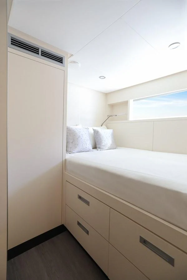 A cozy guest stateroom with a comfortable bed and ample storage space. aboard OCEAN ALEXANDER 28L Yacht for Sale