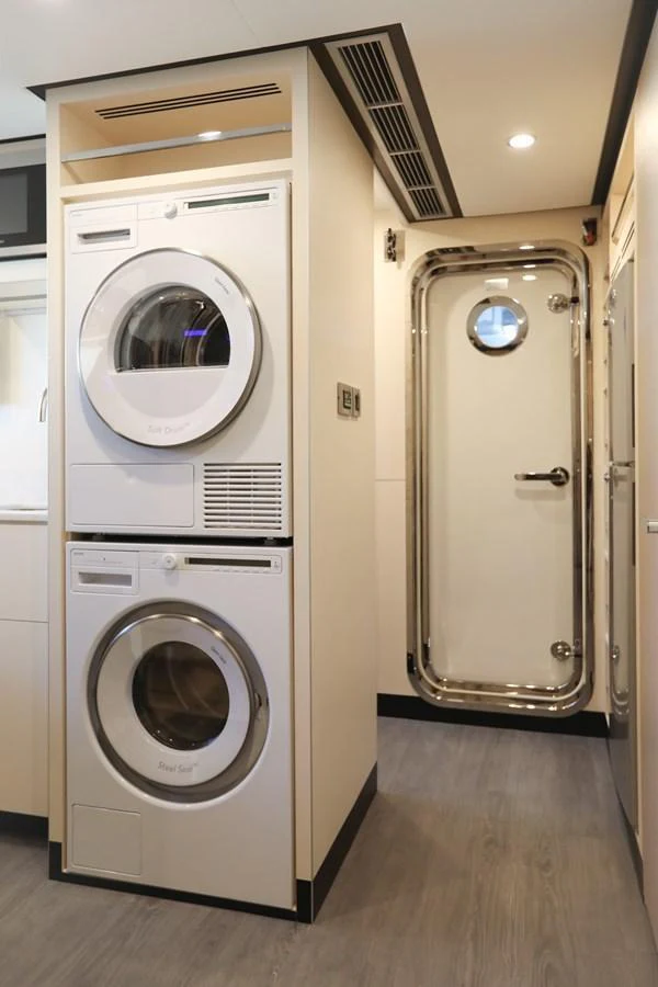 The yacht's laundry room features modern appliances and a sleek design. aboard OCEAN ALEXANDER 28L Yacht for Sale