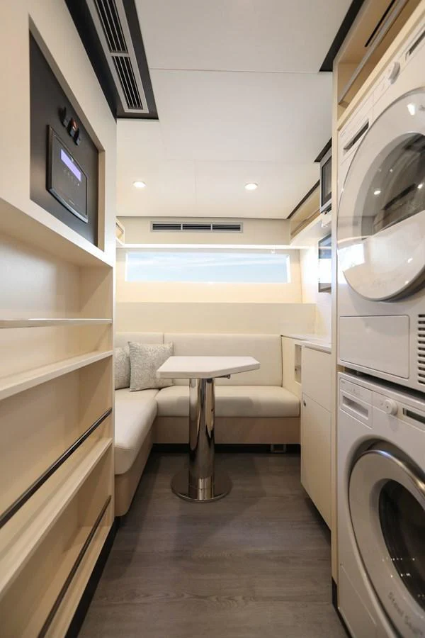 The yacht's laundry area features modern appliances and a cozy seating nook. aboard OCEAN ALEXANDER 28L Yacht for Sale