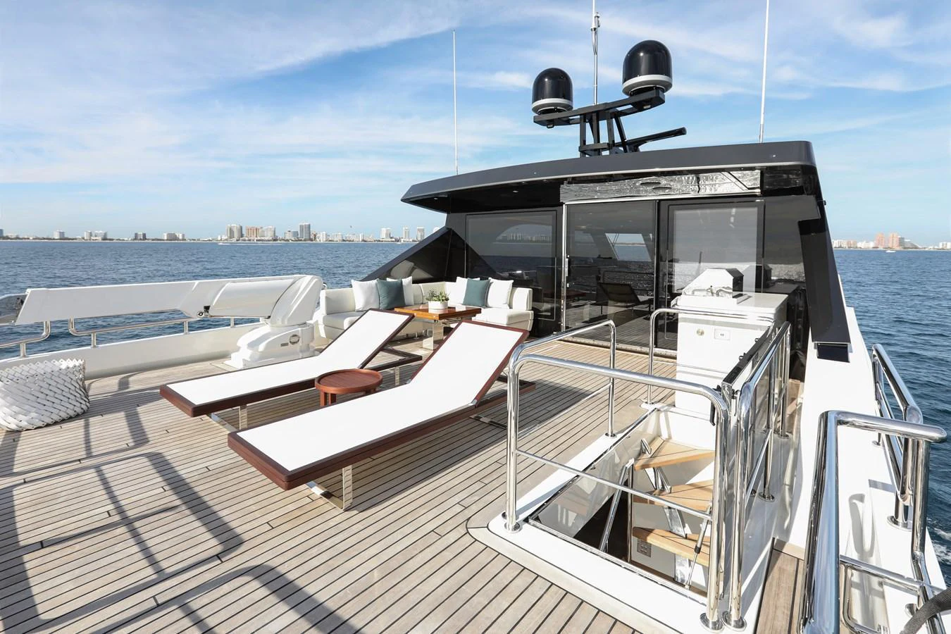 The yacht's sundeck features luxurious sun loungers and a spacious seating area with stunning ocean views. aboard OCEAN ALEXANDER 28L Yacht for Sale