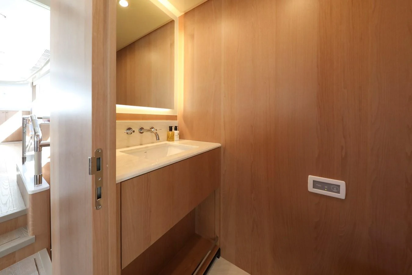 The yacht's bathroom features a sleek wooden design with modern fixtures. aboard OCEAN ALEXANDER 28L Yacht for Sale
