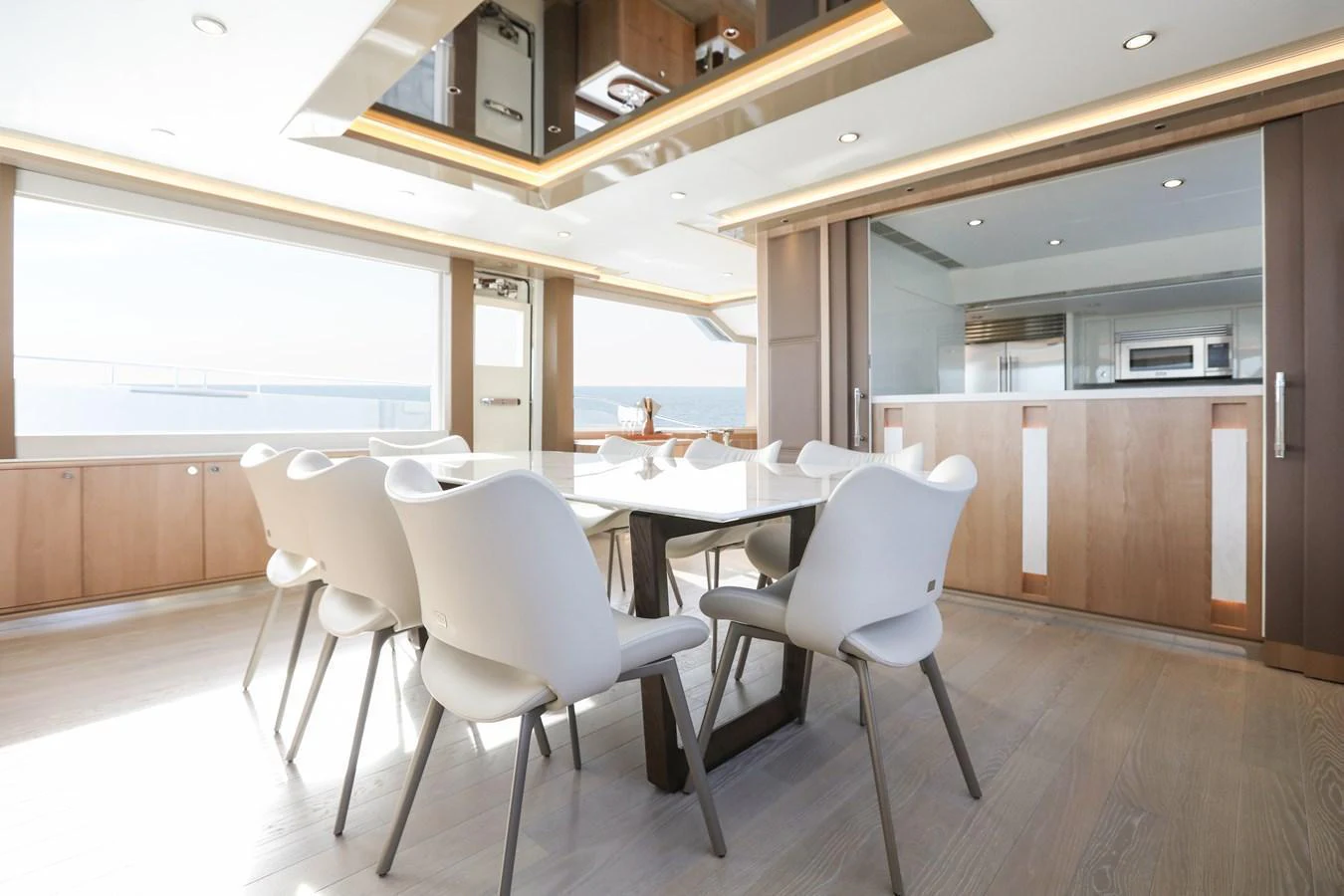 The yacht's dining area features modern furnishings with ample natural light and a sleek design. aboard OCEAN ALEXANDER 28L Yacht for Sale