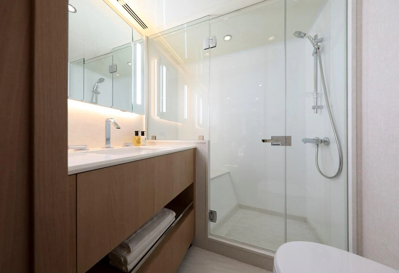 The yacht's bathroom features a sleek design with a glass-enclosed shower and modern fixtures. aboard OCEAN ALEXANDER 28L Yacht for Sale