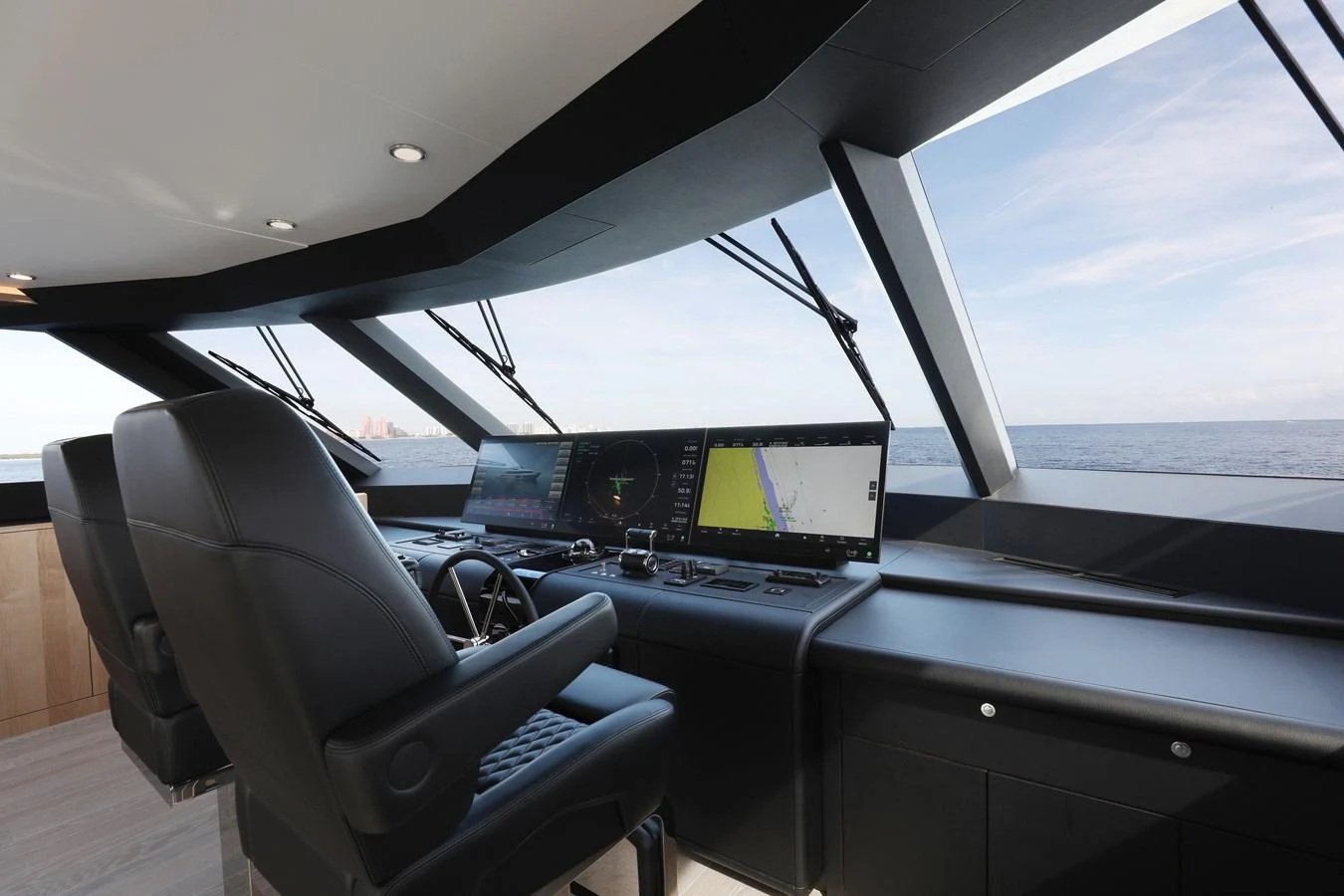 The helm station offers a sleek and modern command center with expansive ocean views. aboard OCEAN ALEXANDER 28L Yacht for Sale