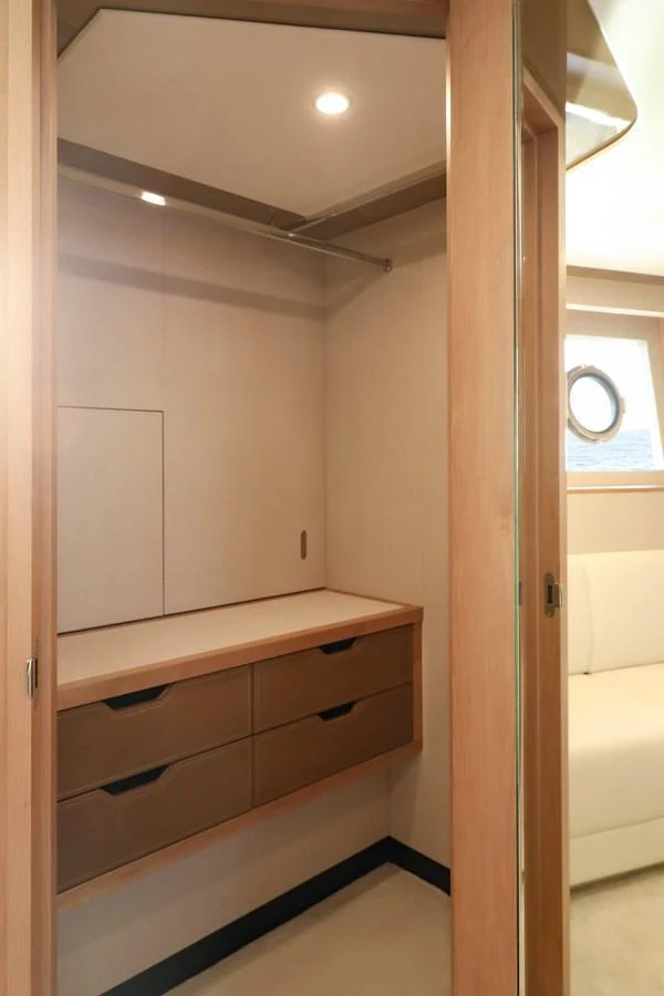 A well-appointed closet with ample storage space and modern finishes. aboard OCEAN ALEXANDER 28L Yacht for Sale