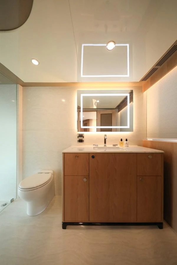The bathroom features modern fixtures and a sleek, minimalist design. aboard OCEAN ALEXANDER 28L Yacht for Sale
