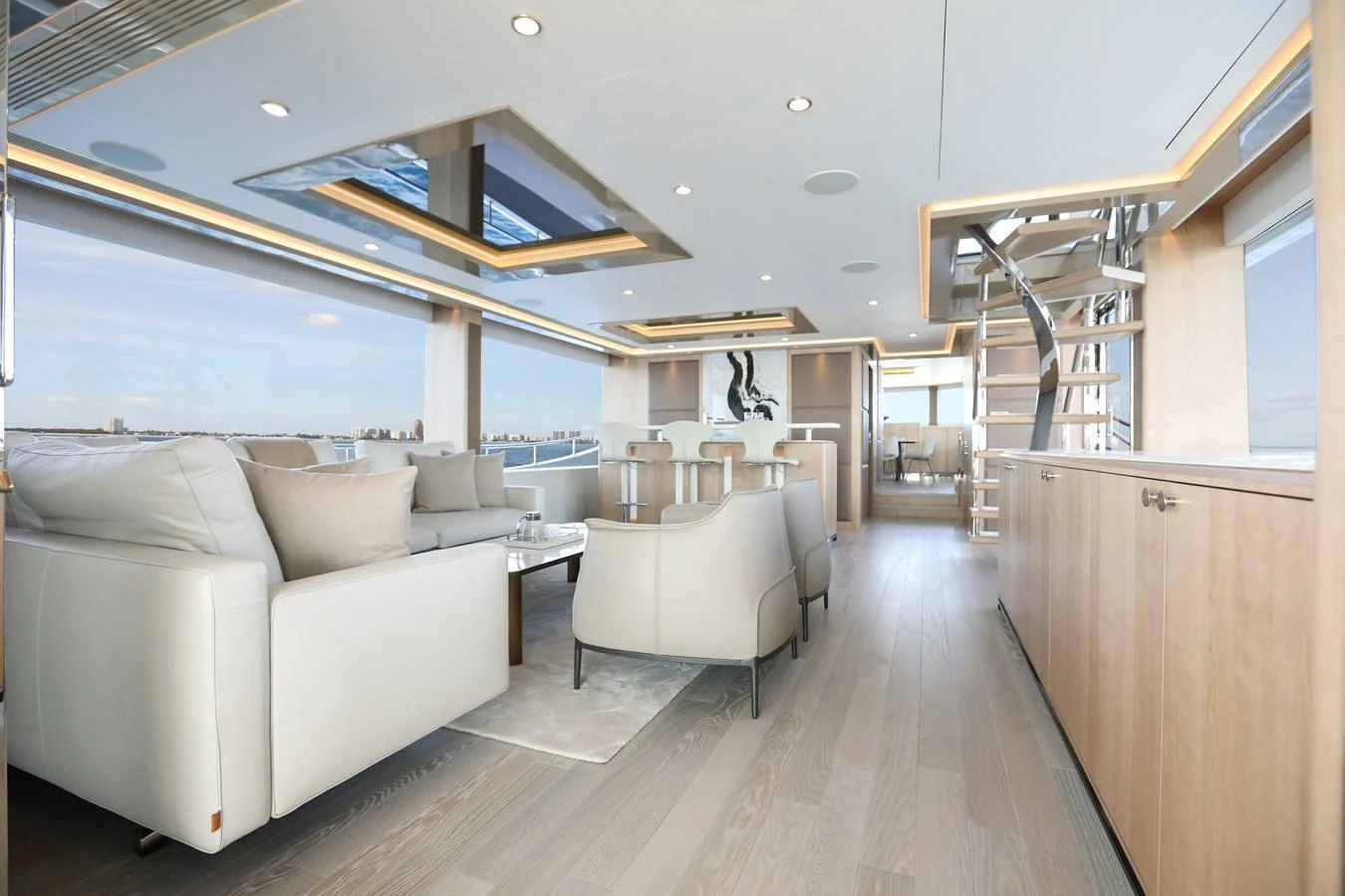 The salon features modern furnishings with ample natural light and a sophisticated ambiance. aboard OCEAN ALEXANDER 28L Yacht for Sale