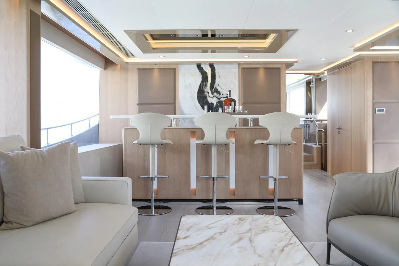 The salon features a modern bar area with stylish seating and elegant decor. aboard OCEAN ALEXANDER 28L Yacht for Sale