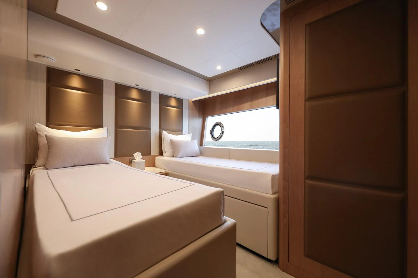 The guest stateroom features twin beds with elegant wood paneling and soft lighting. aboard OCEAN ALEXANDER 28L Yacht for Sale