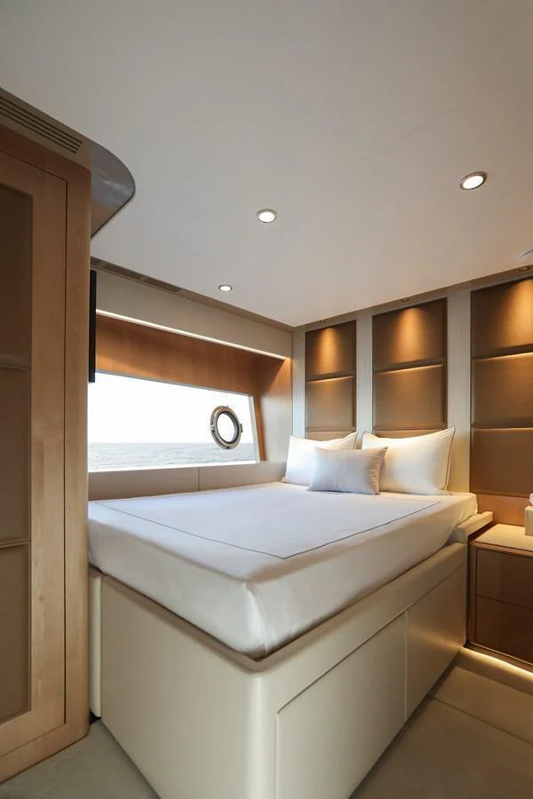 A cozy stateroom with a large window offering a serene ocean view. aboard OCEAN ALEXANDER 28L Yacht for Sale