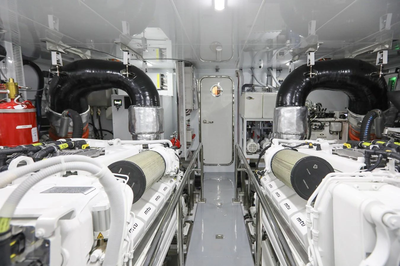 The image showcases the yacht's pristine engine room with well-maintained machinery. aboard OCEAN ALEXANDER 28L Yacht for Sale