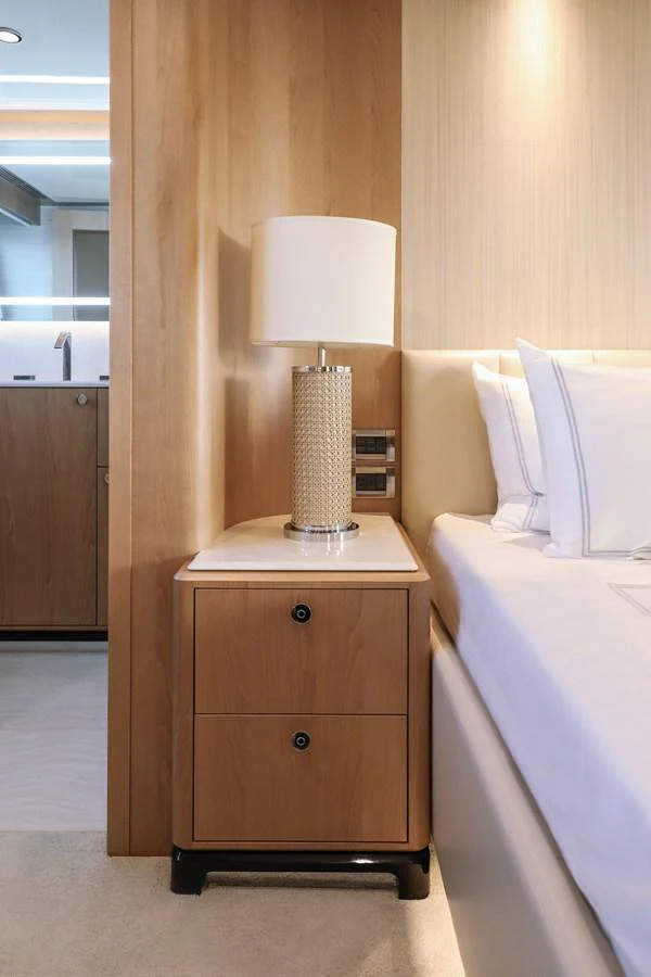 A cozy stateroom featuring a bedside table with a stylish lamp and luxurious bedding. aboard OCEAN ALEXANDER 28L Yacht for Sale