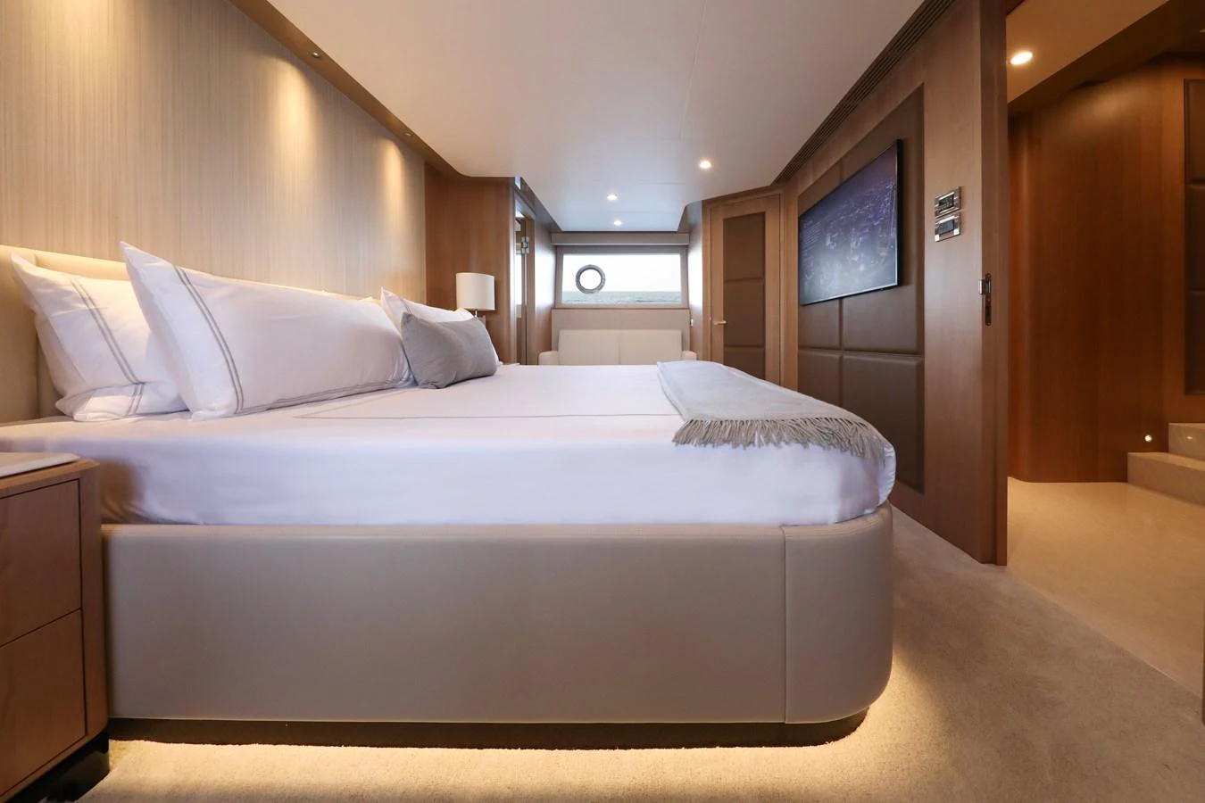 The luxurious stateroom features a large, comfortable bed and elegant wood paneling. aboard OCEAN ALEXANDER 28L Yacht for Sale