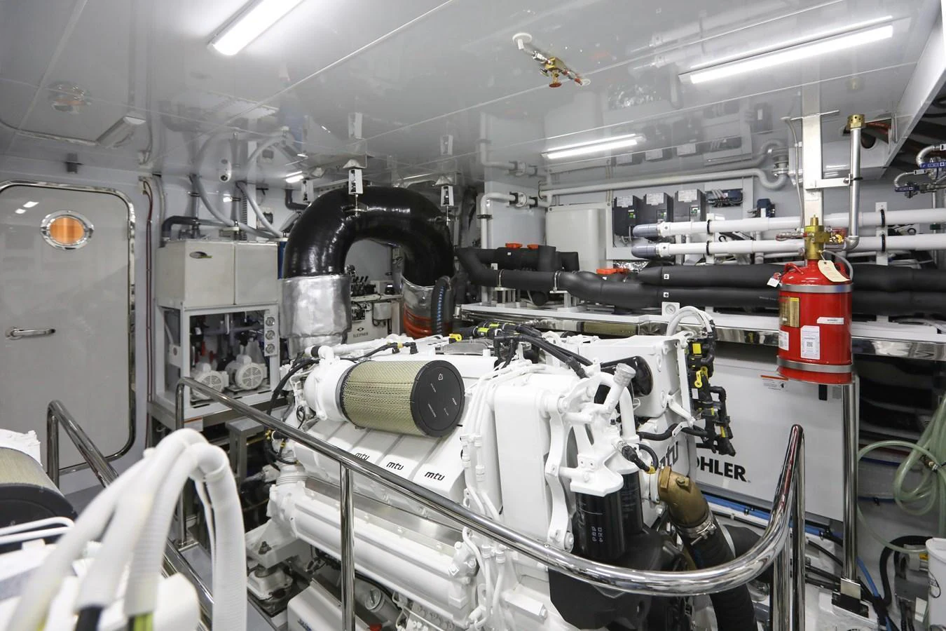 The image showcases the well-maintained engine room of the yacht, highlighting its advanced mechanical systems. aboard OCEAN ALEXANDER 28L Yacht for Sale