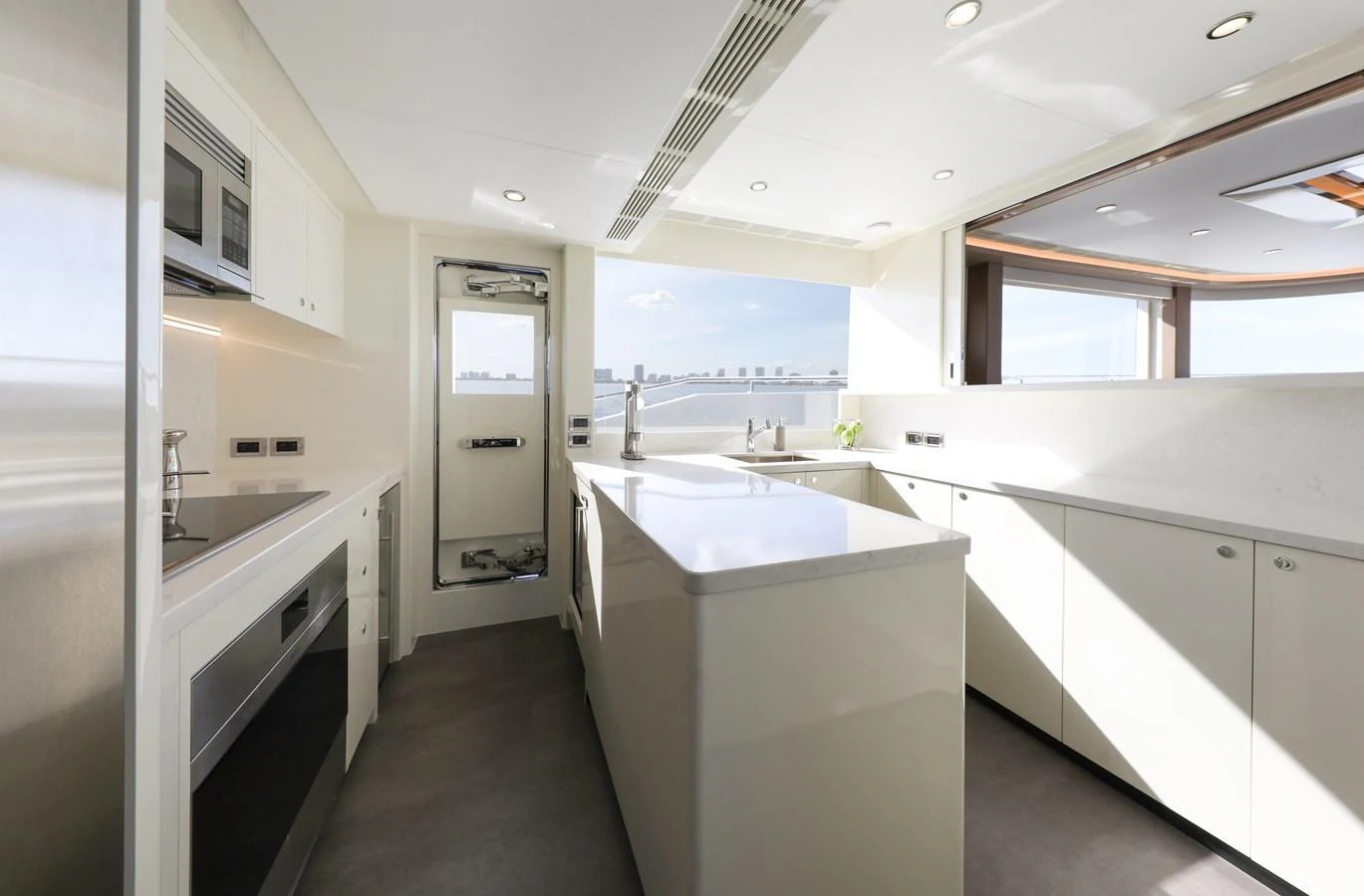 The galley features modern appliances and ample counter space, bathed in natural light. aboard OCEAN ALEXANDER 28L Yacht for Sale