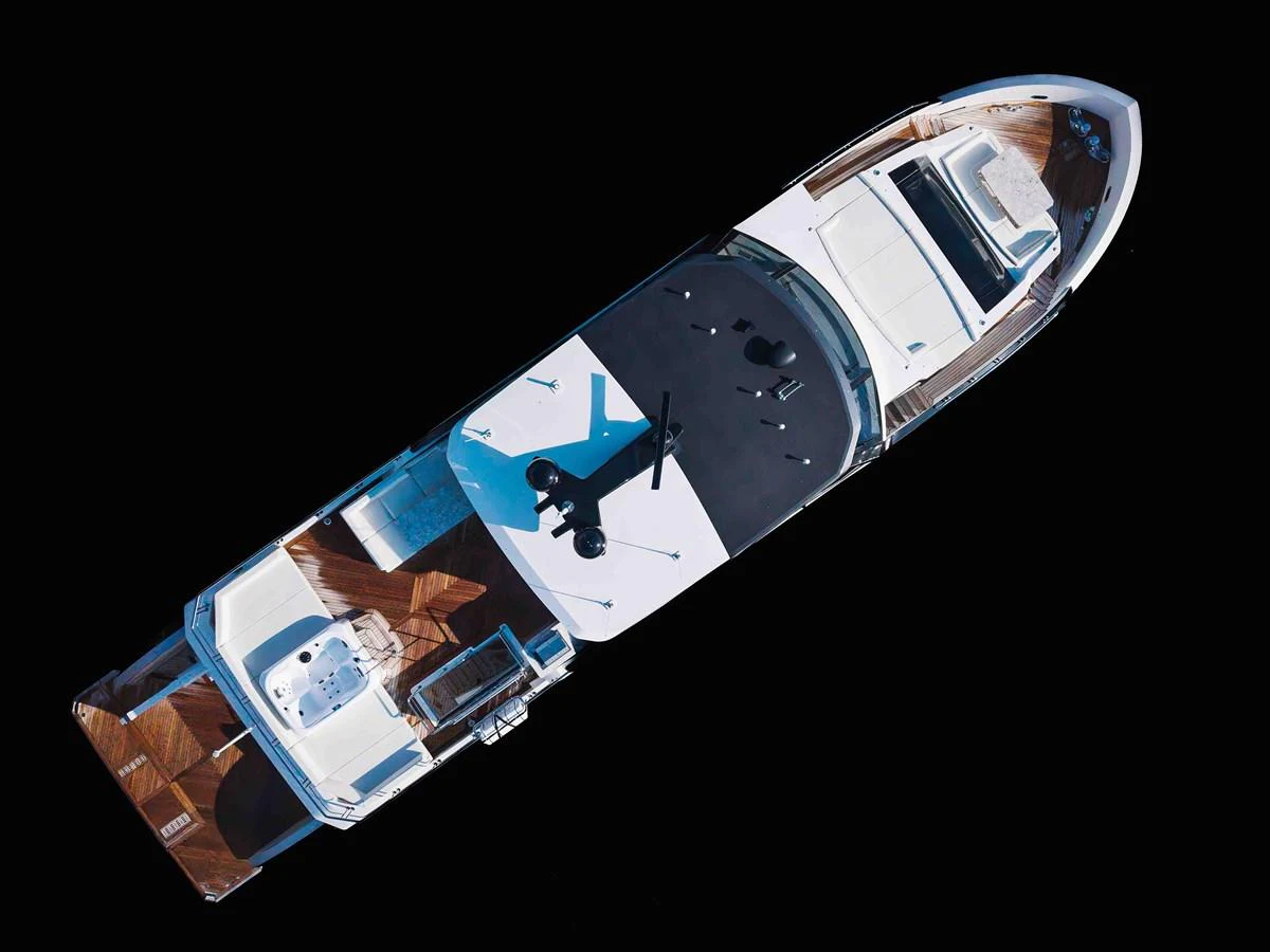 A stunning aerial view of a sleek yacht showcasing its elegant design and spacious deck areas. aboard CHAOS Yacht for Sale