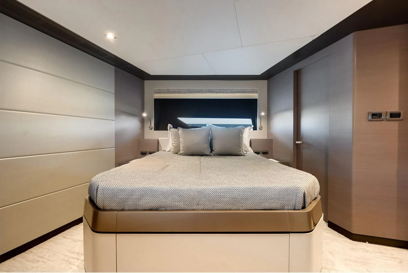 The stateroom features a luxurious bed with modern decor and ample lighting. aboard CHAOS Yacht for Sale