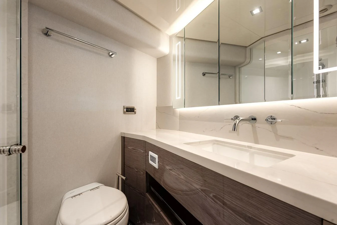 The yacht's bathroom features a sleek design with modern fixtures and ample lighting. aboard CHAOS Yacht for Sale