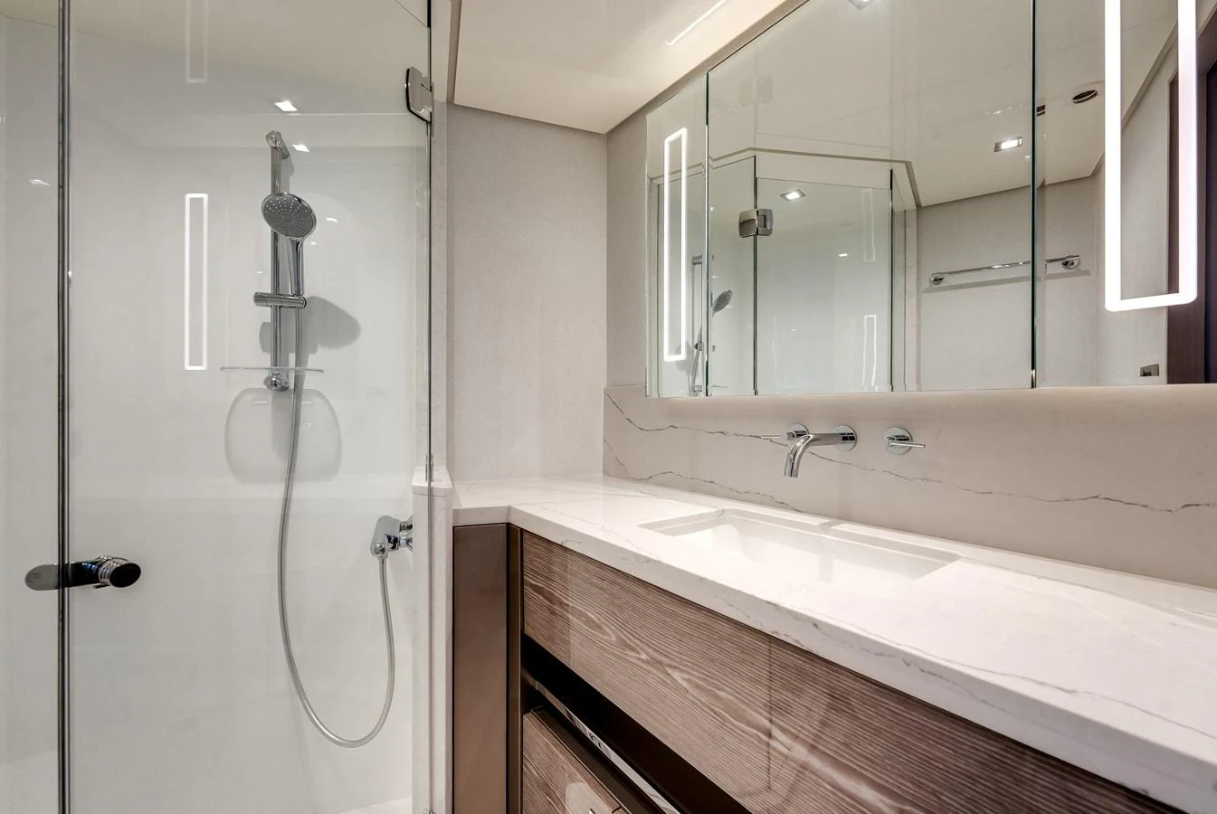 The yacht's bathroom features a sleek design with modern fixtures and a spacious shower area. aboard CHAOS Yacht for Sale