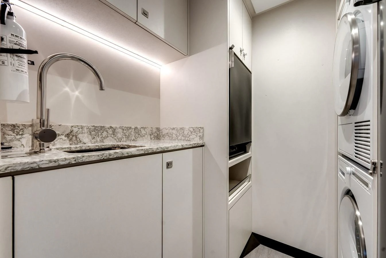 The yacht's galley features modern appliances and sleek design. aboard CHAOS Yacht for Sale