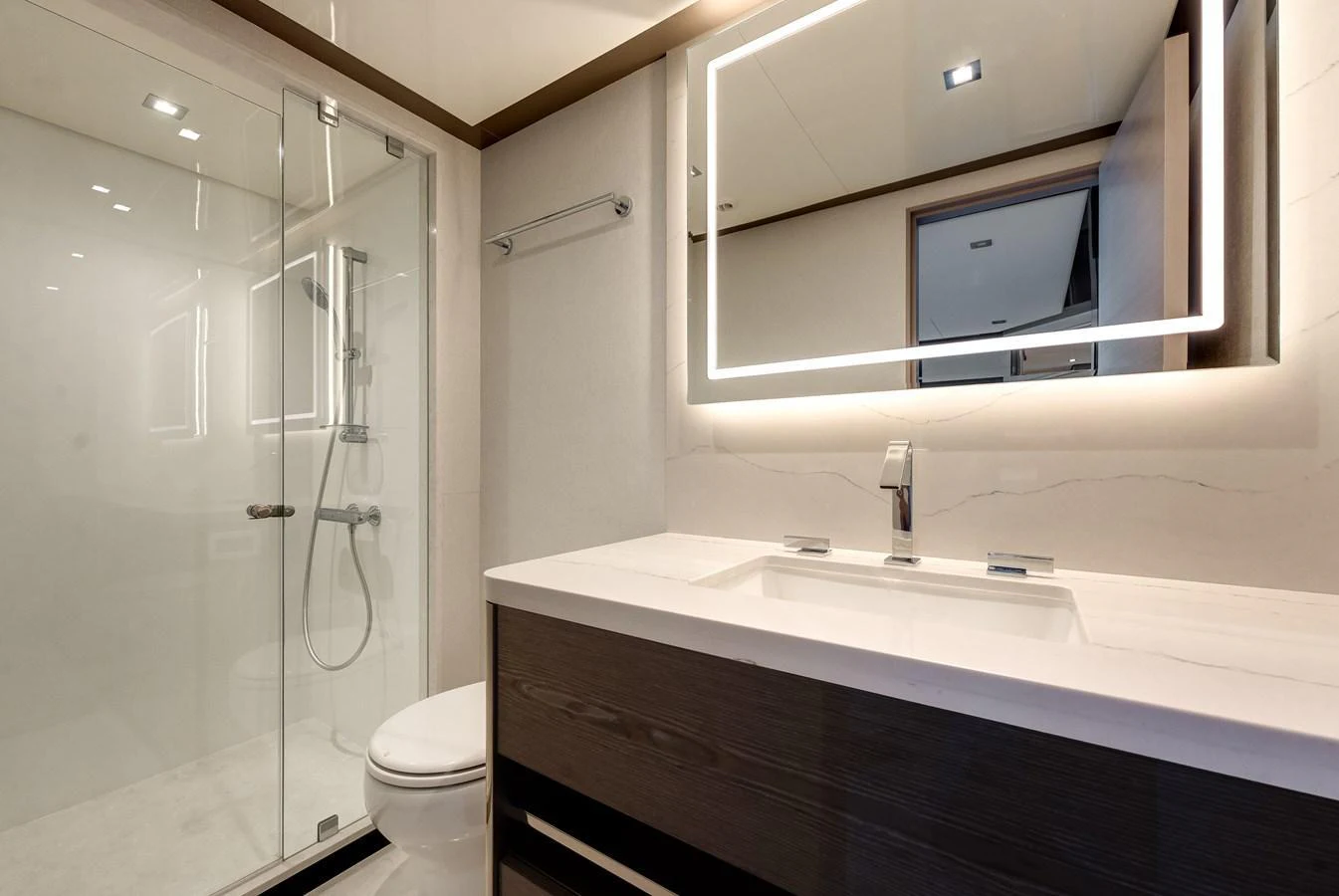 The yacht's bathroom features a modern design with a spacious shower and sleek vanity. aboard CHAOS Yacht for Sale
