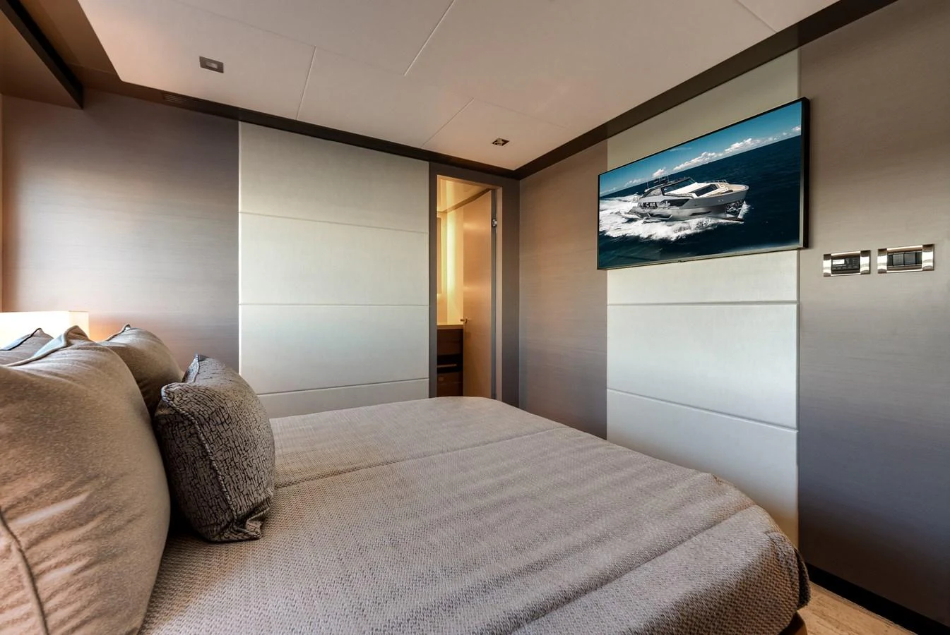 The stateroom offers a serene and comfortable retreat with modern decor and luxurious bedding. aboard CHAOS Yacht for Sale
