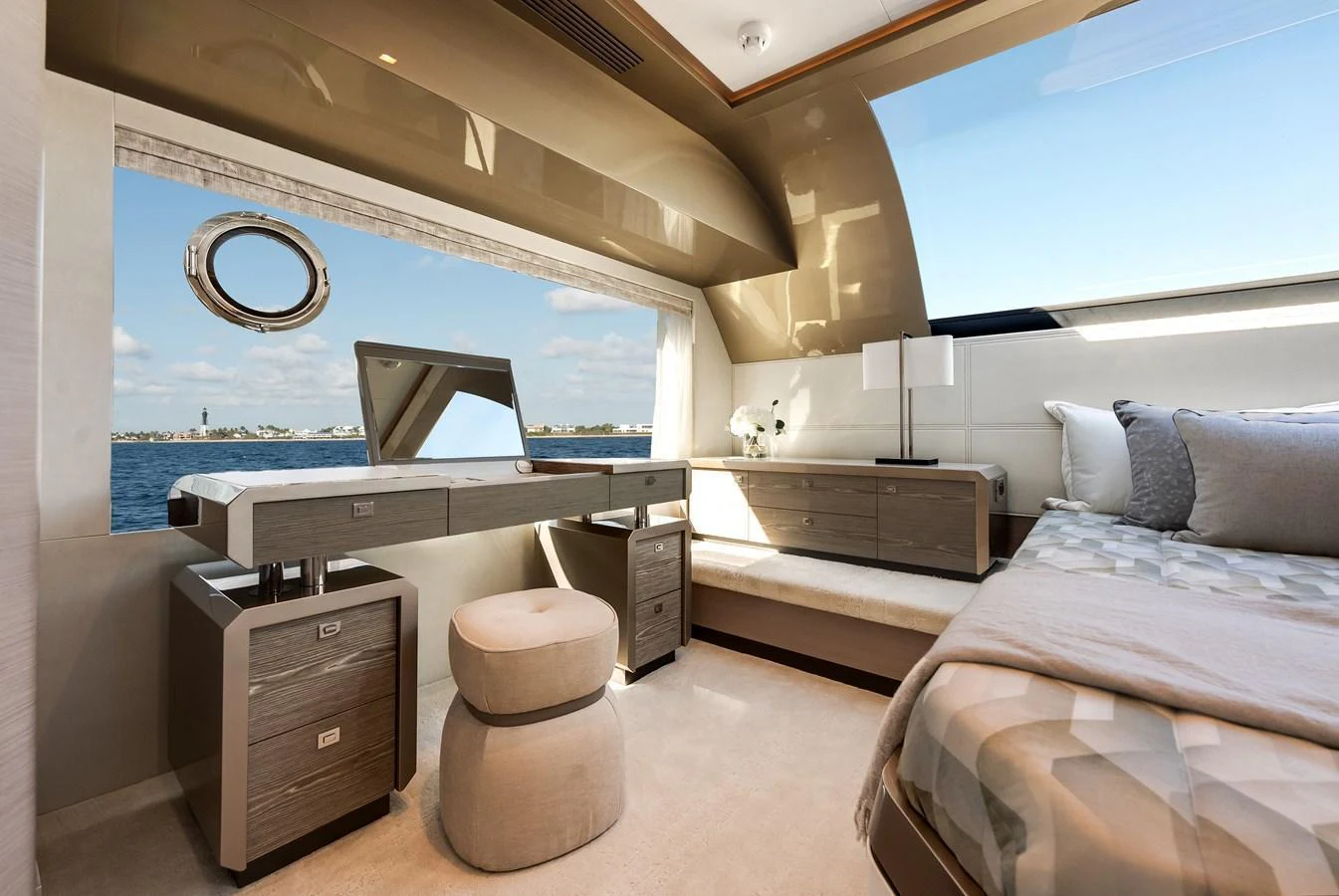 The stateroom features a luxurious vanity area with a scenic ocean view. aboard CHAOS Yacht for Sale