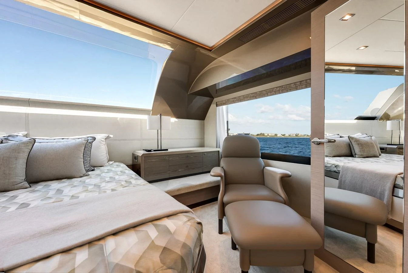 A luxurious stateroom with a large window offering stunning sea views. aboard CHAOS Yacht for Sale