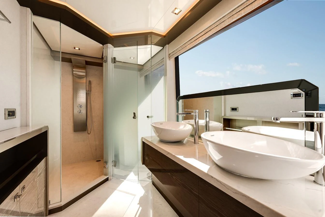 The yacht's bathroom features modern fixtures and a spacious shower area with ample natural light. aboard CHAOS Yacht for Sale