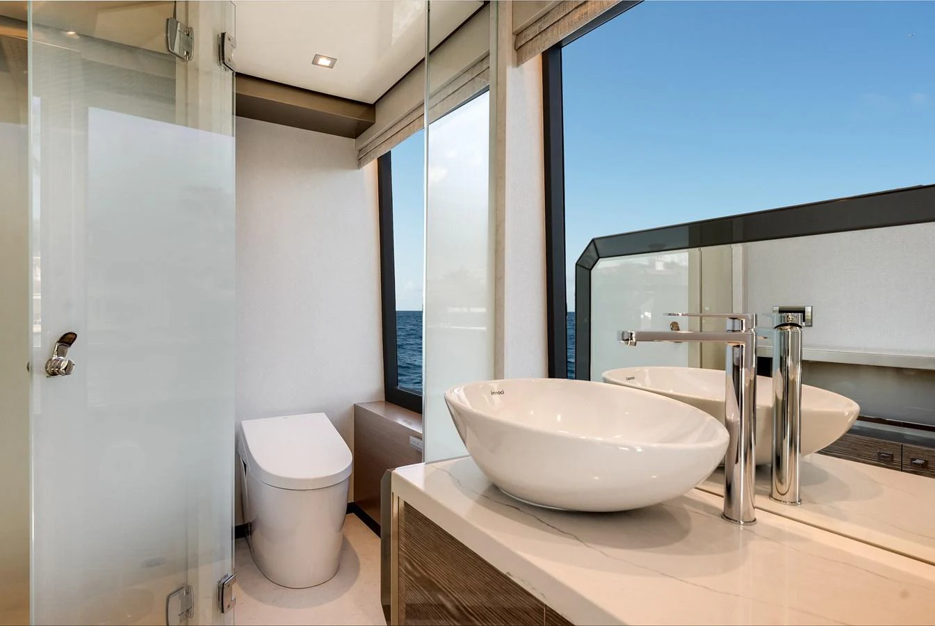 A modern yacht bathroom with a sleek design and ocean view. aboard CHAOS Yacht for Sale